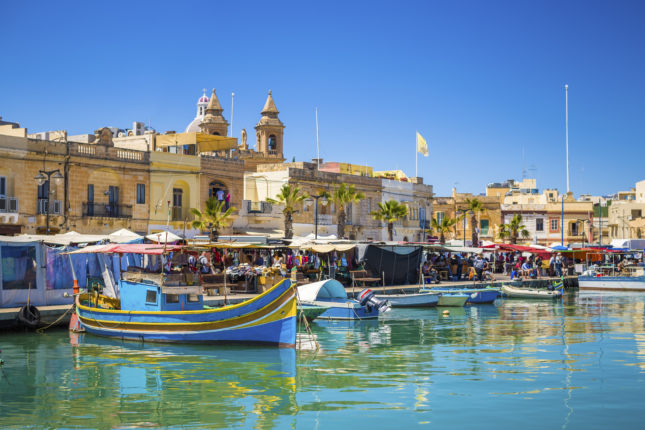 Marsaxlokk market with traditional Luzzu fishing boats