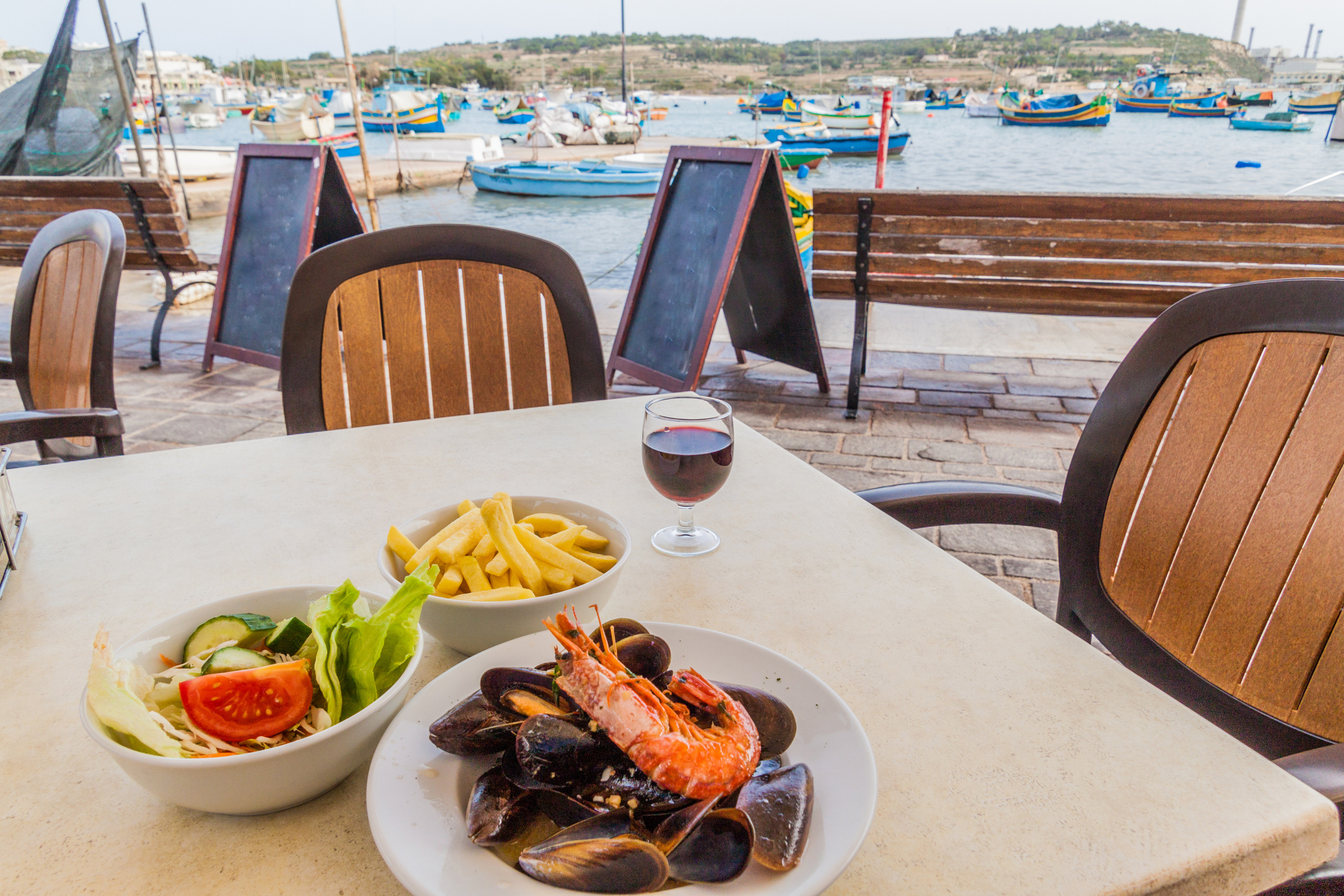 Sea food dish with fries and salad in a retaurant