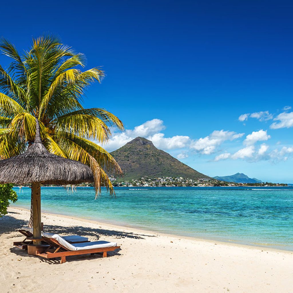 Loungers and umbrella on tropical beach in Mauritius