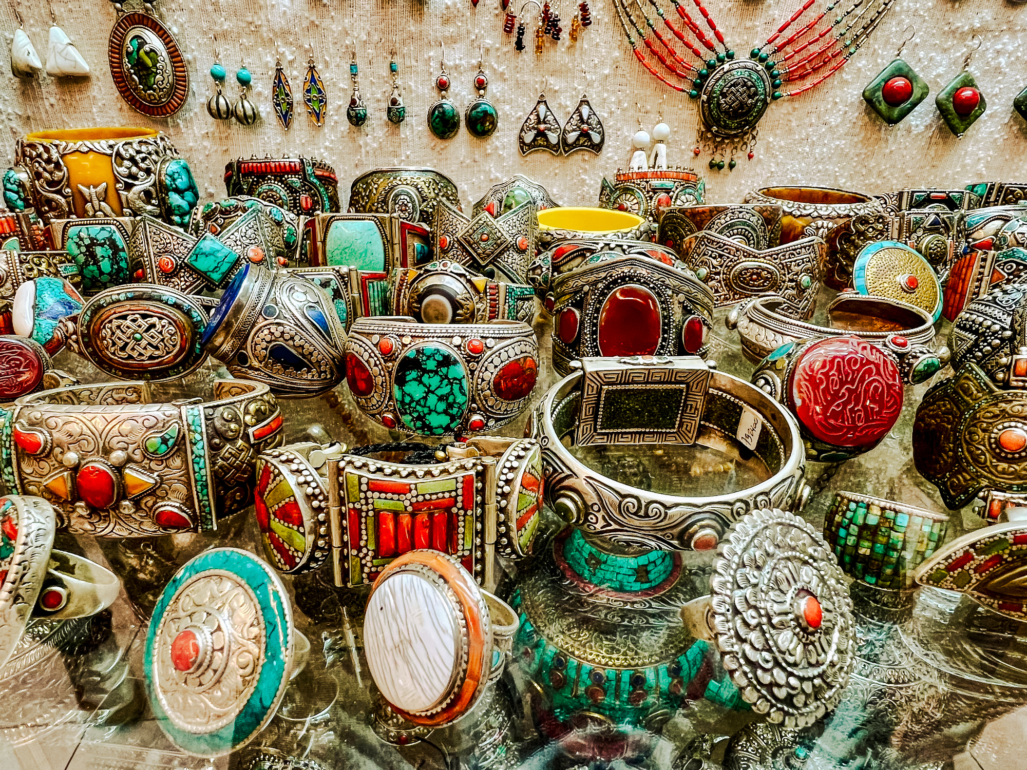 A selection of traditional jewelry and ceramics displayed at a souk vendor in Tangier